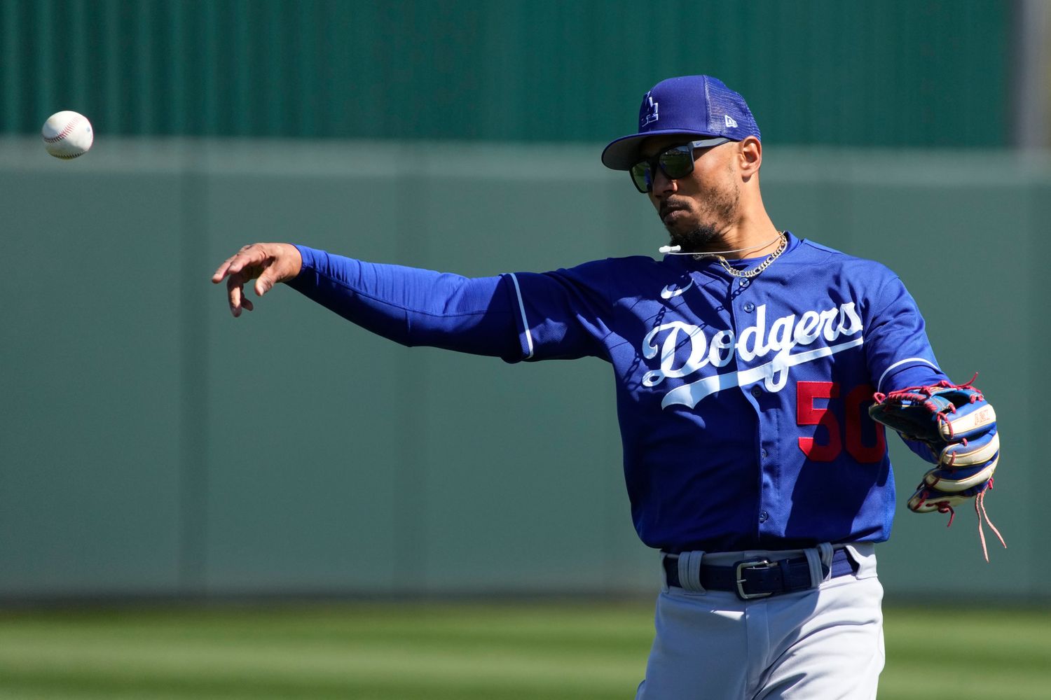 Mookie Betts throws a ball toward third base in a spring training game for the Dodgers.